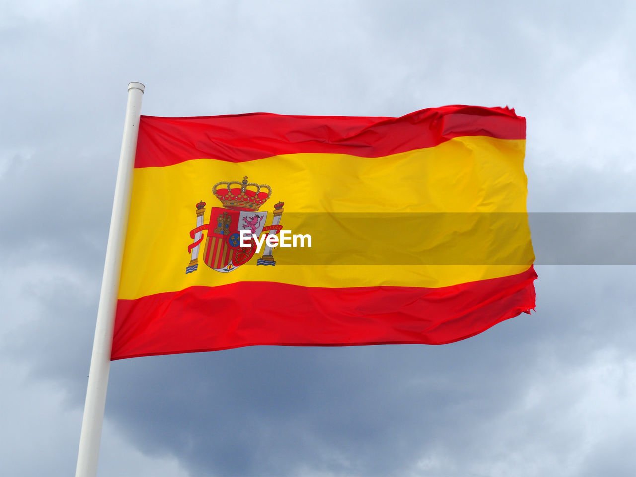 Low angle view of spanish flag against sky
