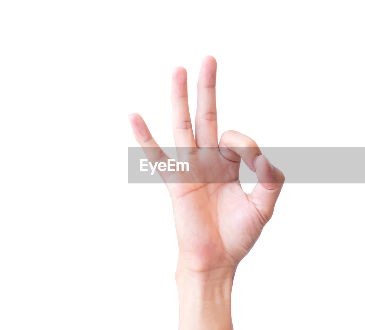 Close-up of hand showing ok sign against white background