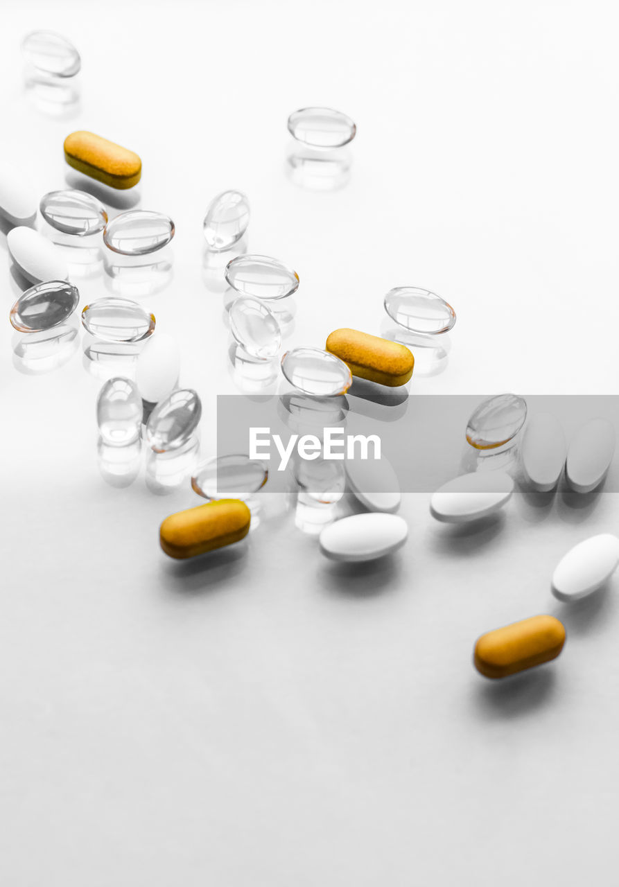 close-up of pills and medicines over white background