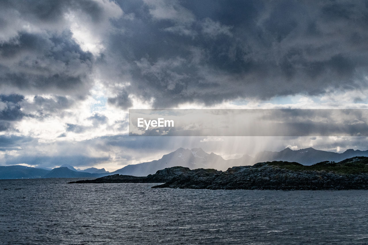 Scenic rainstorm over lofoten mountains, sea and clouds 