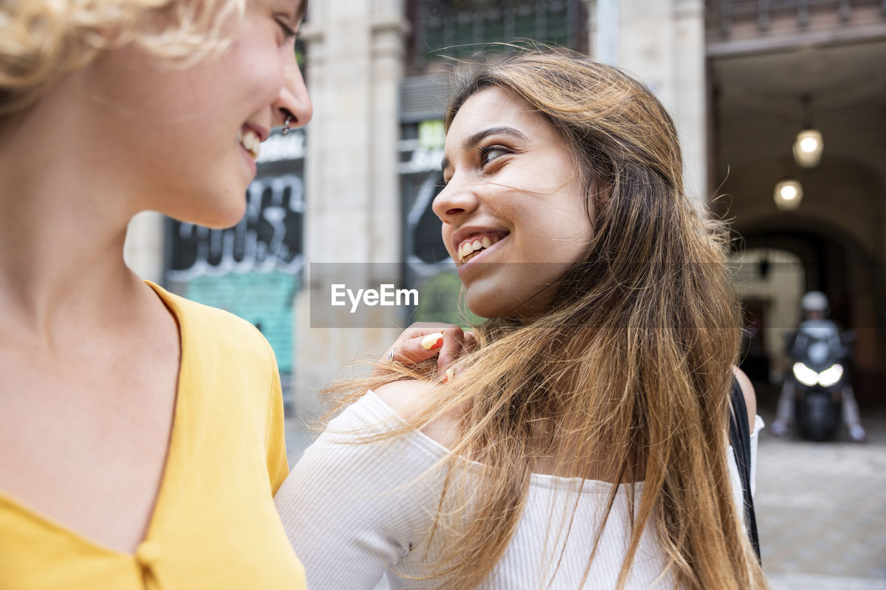 Smiling young woman spending leisure time with friend