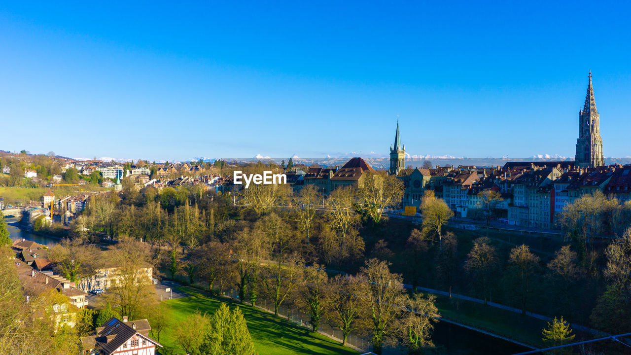 Panoramic view of buildings against blue sky