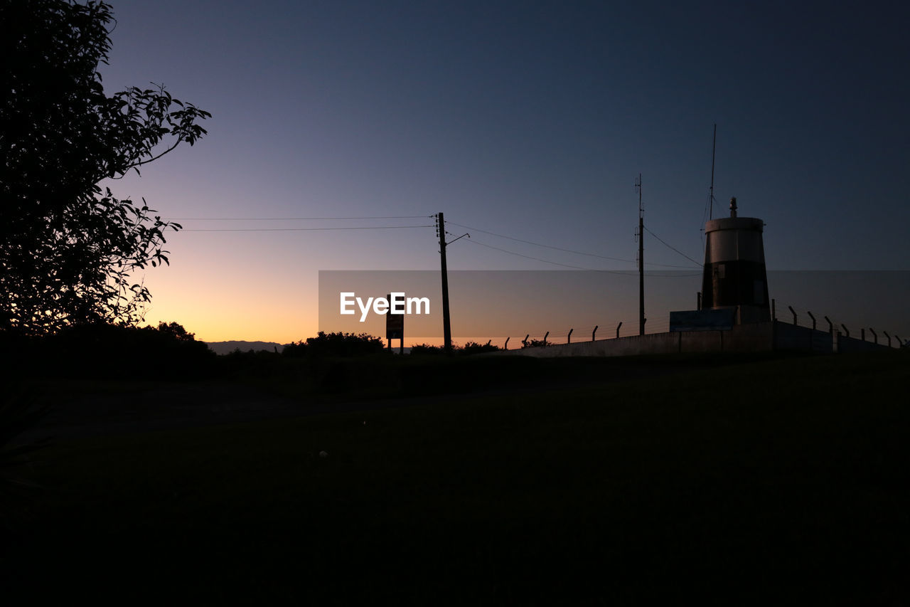 Low angle view of industrial building at sunset