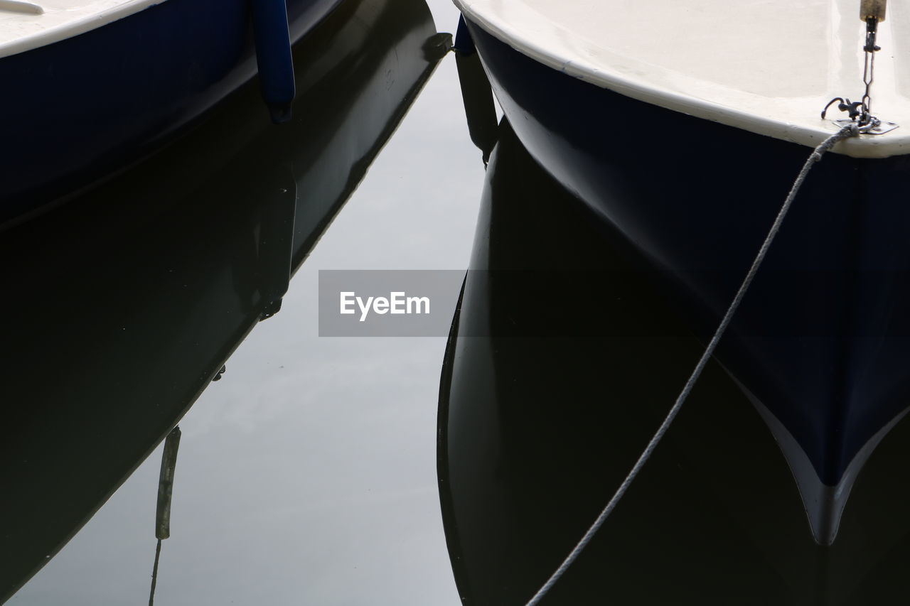 Close-up of boat moored on lake