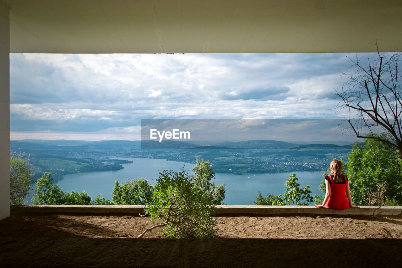 Woman looking at view of mountains against sky