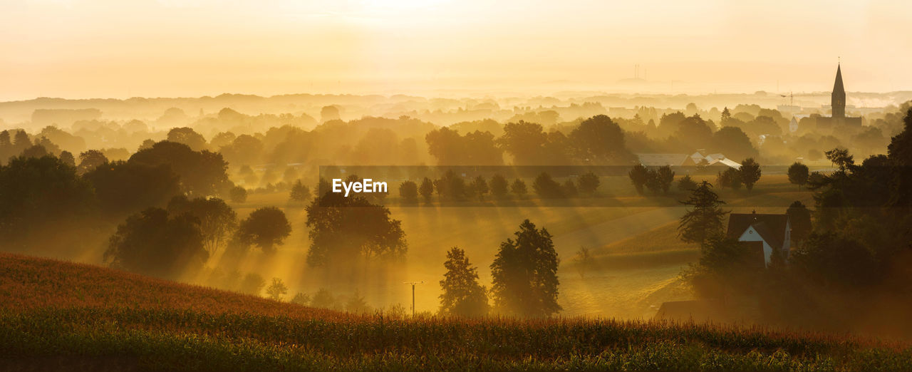 Sunrise over village and farmland