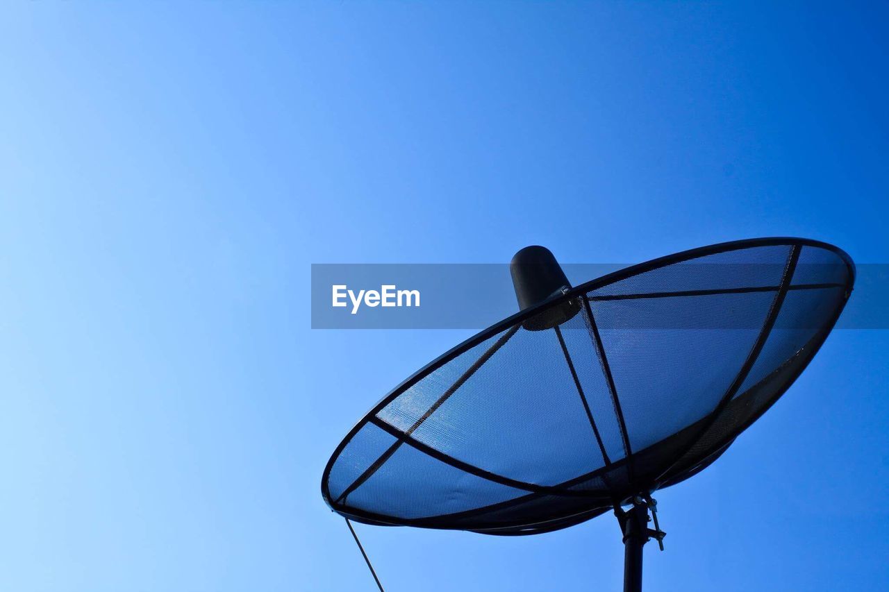 LOW ANGLE VIEW OF TELEPHONE POLE AGAINST BLUE SKY