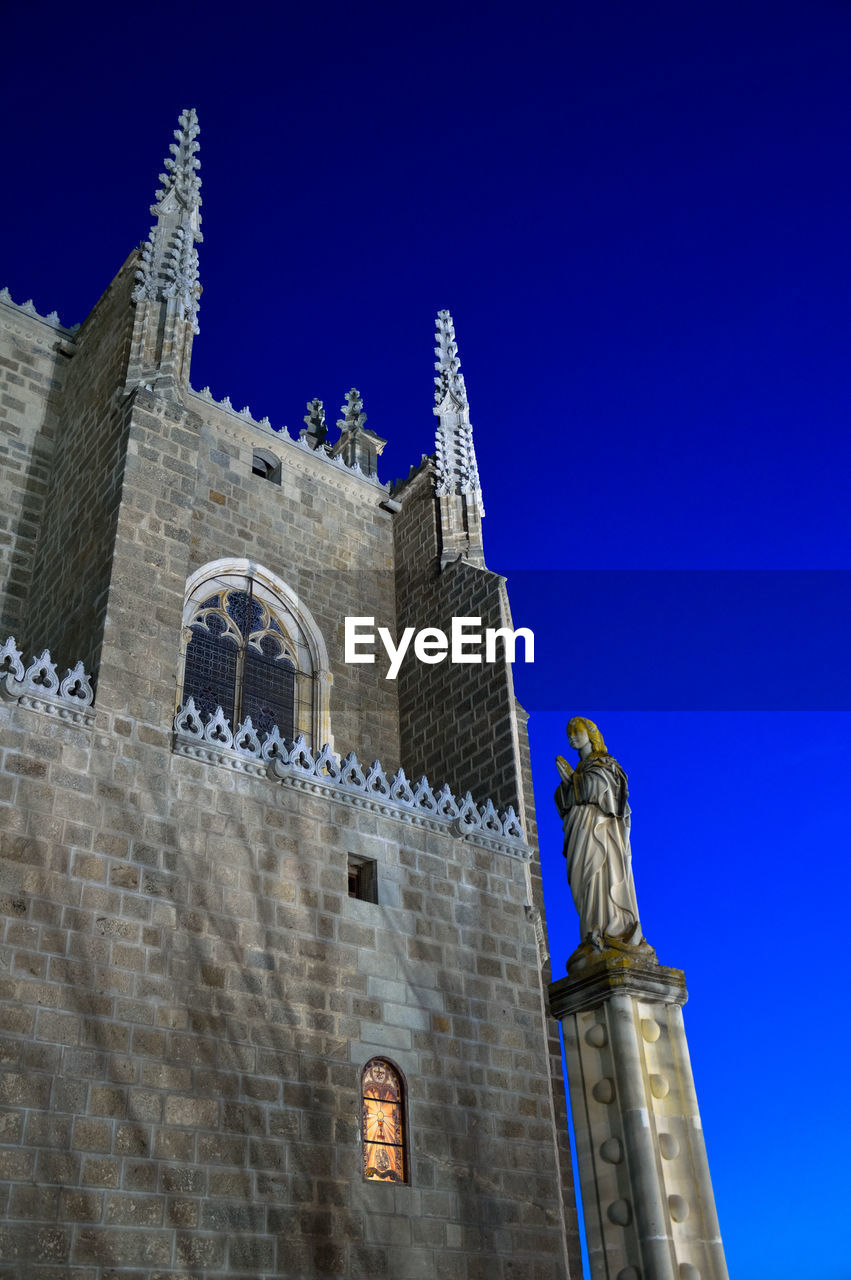 Low angle view of church with statue