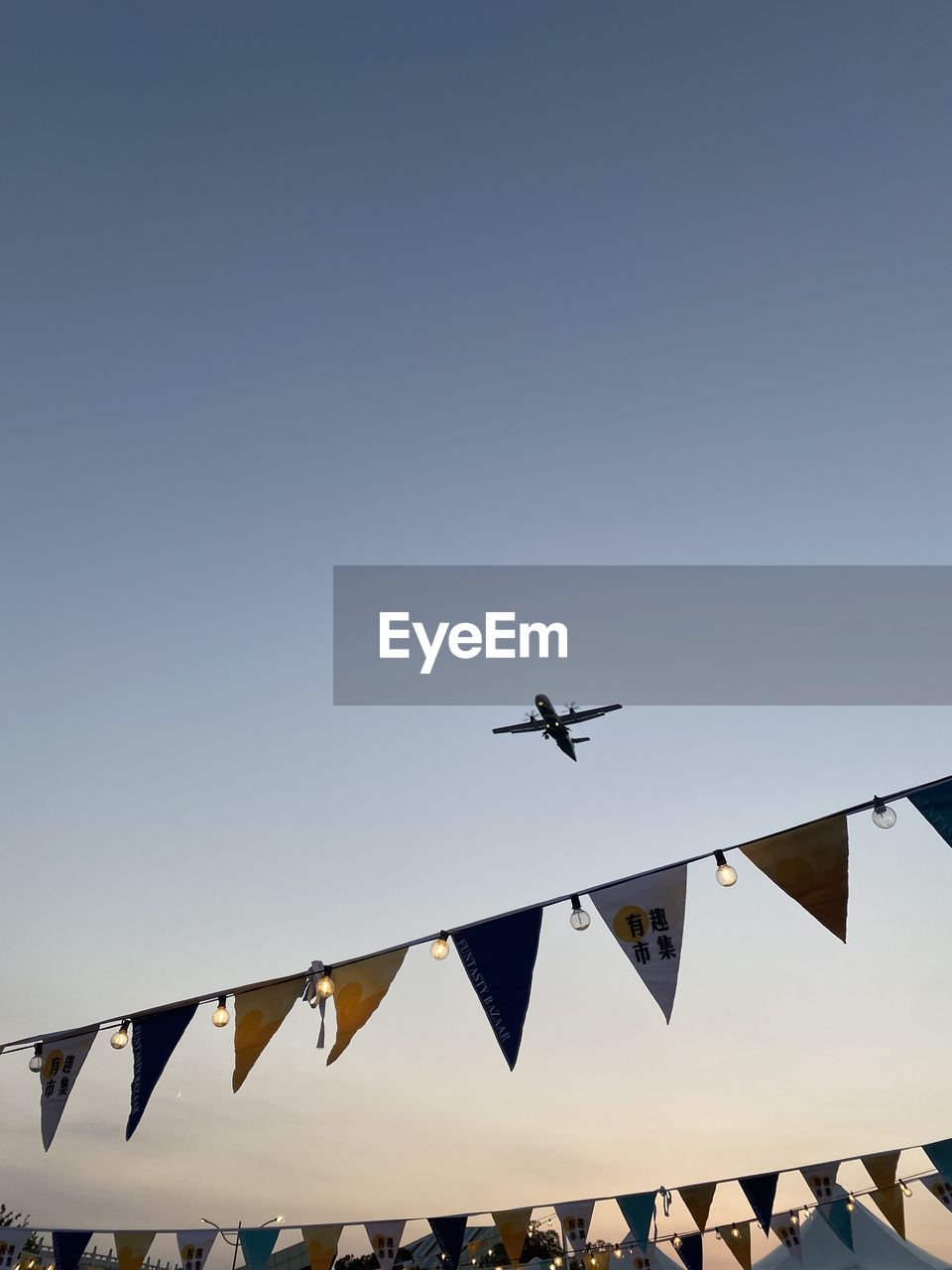 Low angle view of airplane flying against clear sky