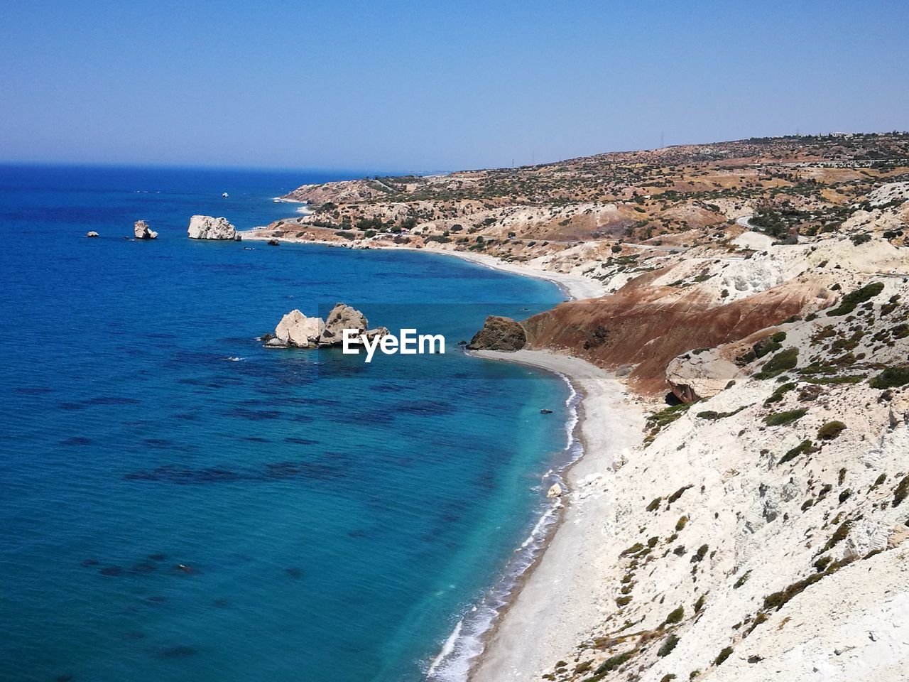 Scenic view of sea against clear blue sky