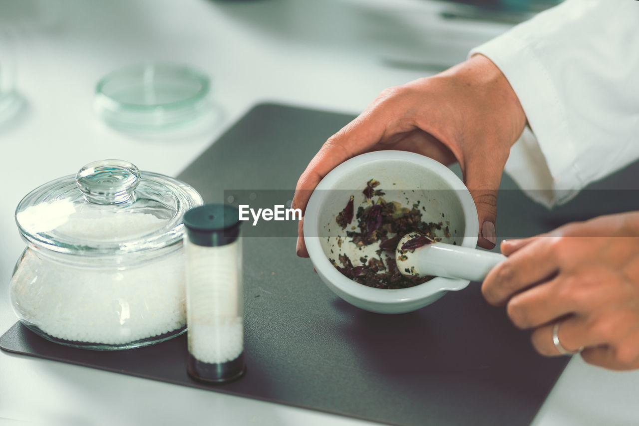 Cropped image of female chef preparing food in commercial kitchen