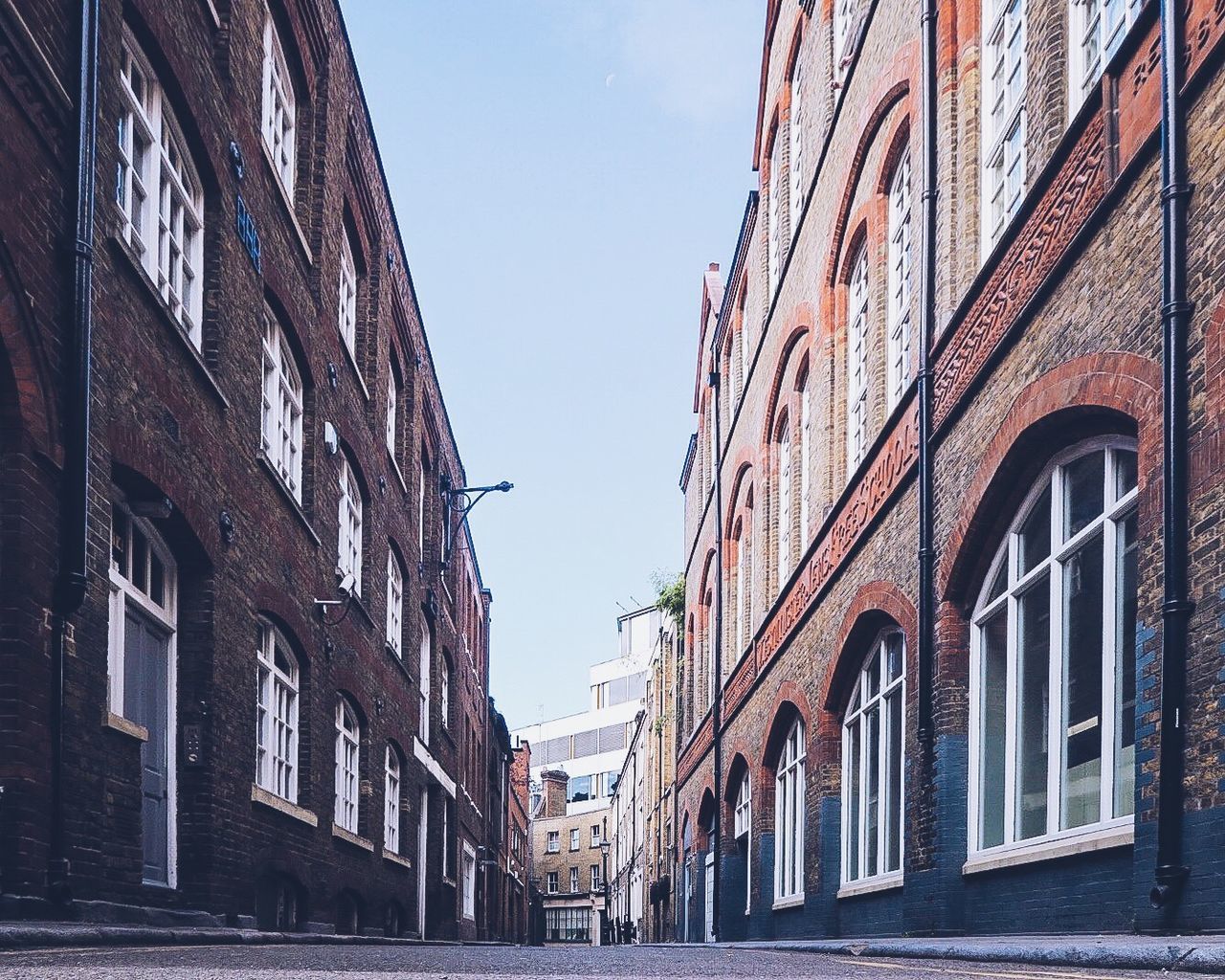 Street amidst buildings against sky in city