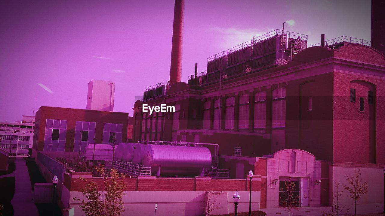 Factory against sky seen from window glass