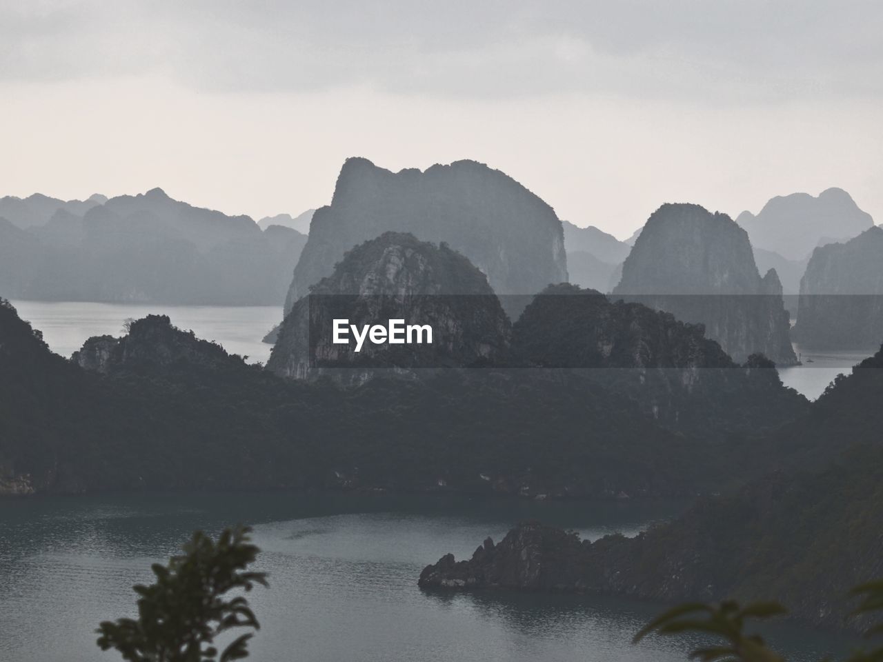 Rock formations on sea in foggy weather