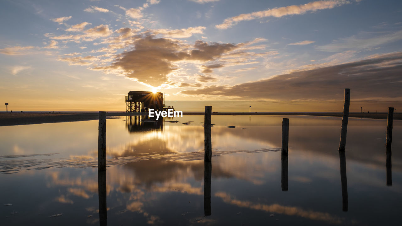 Scenic view of lake against sky during sunset