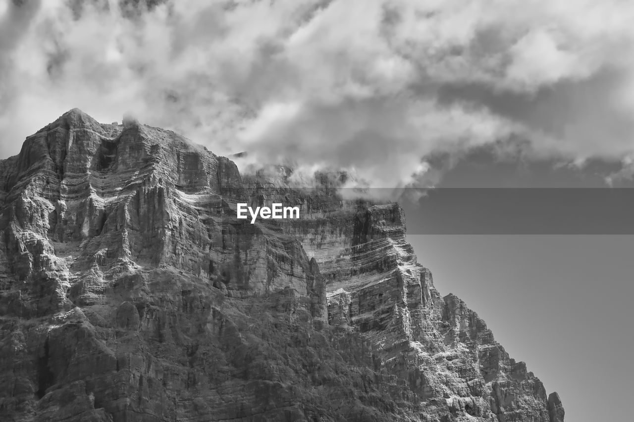mountain, black and white, cloud, sky, rock, monochrome photography, monochrome, nature, environment, scenics - nature, beauty in nature, landscape, mountain range, travel destinations, travel, land, mountain peak, no people, outdoors, fog, tourism, snow, cliff, day, architecture, non-urban scene, rock formation, tranquility, history, geology, white, activity