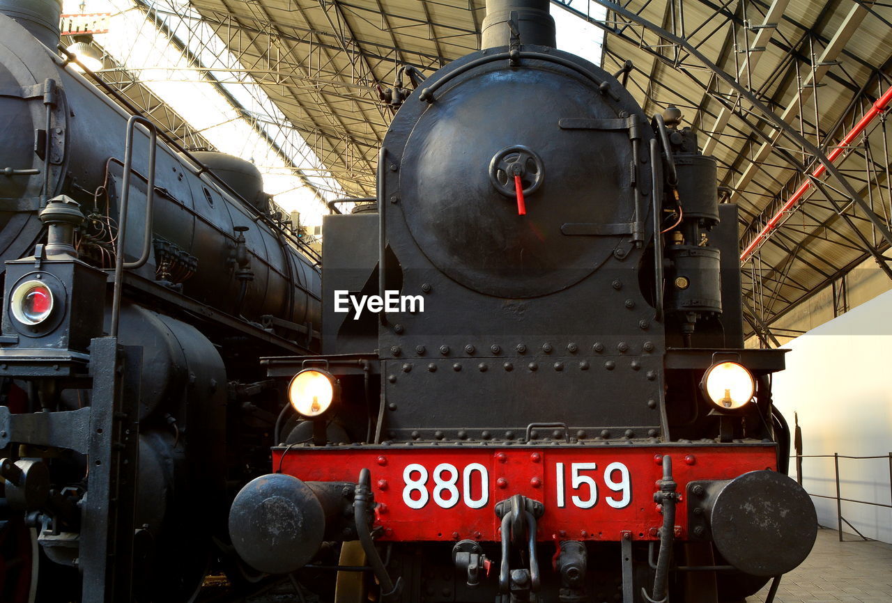 LOW ANGLE VIEW OF ILLUMINATED TRAIN AT MUSEUM