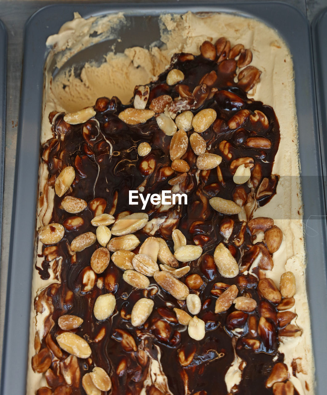 High angle view of ice cream with peanuts and chocolate sauce