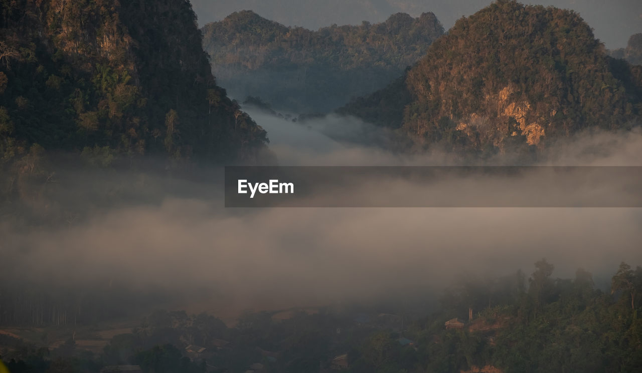 Scenic view of fog with mountains
