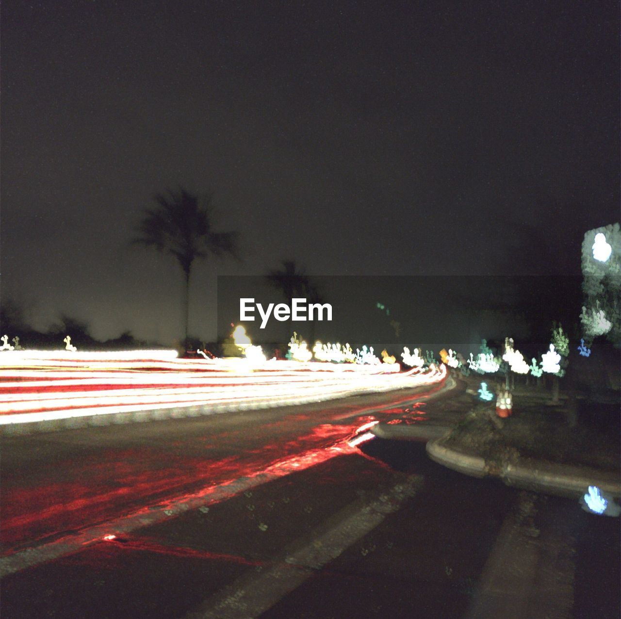 LIGHT TRAILS ON ROAD AT NIGHT