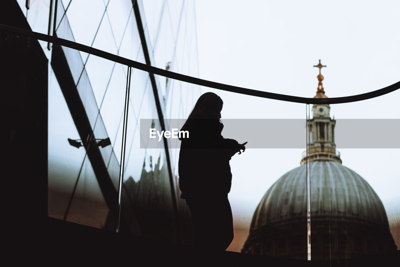 LOW ANGLE VIEW OF SILHOUETTE PERSON AGAINST SKY