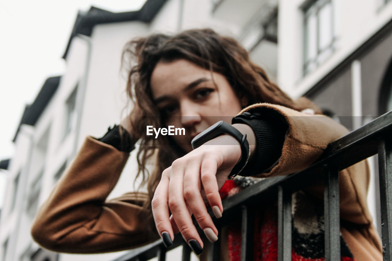 Portrait of young woman holding camera