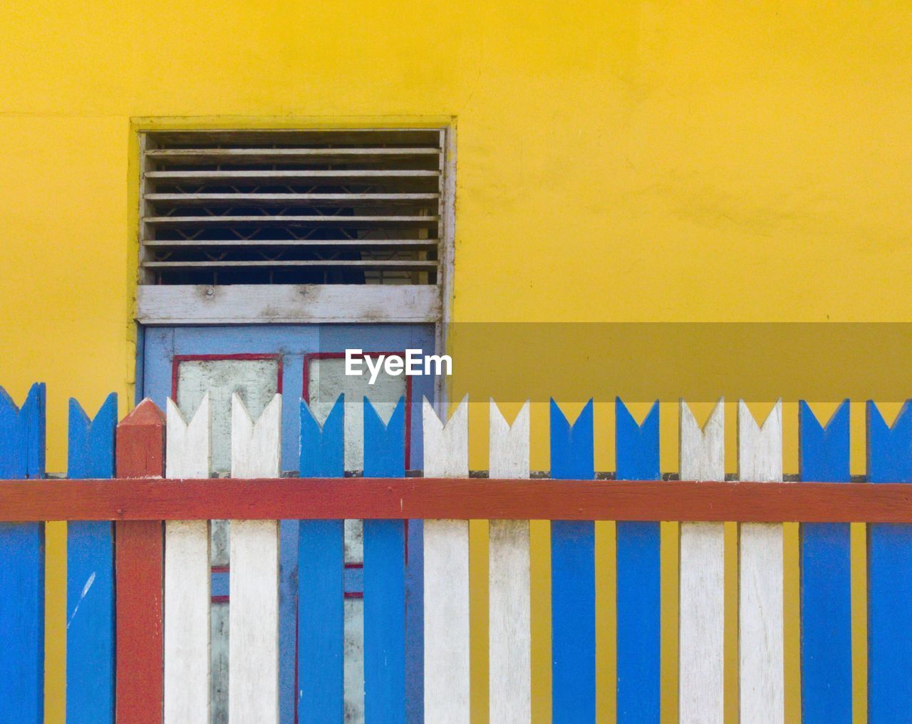 CLOSE-UP OF YELLOW WINDOW ON BUILDING