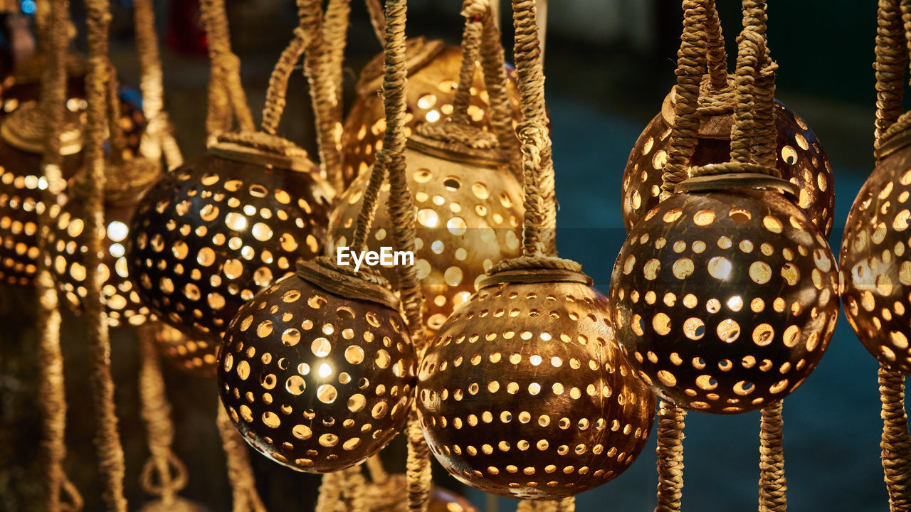 Close-up of illuminated decorations hanging at night