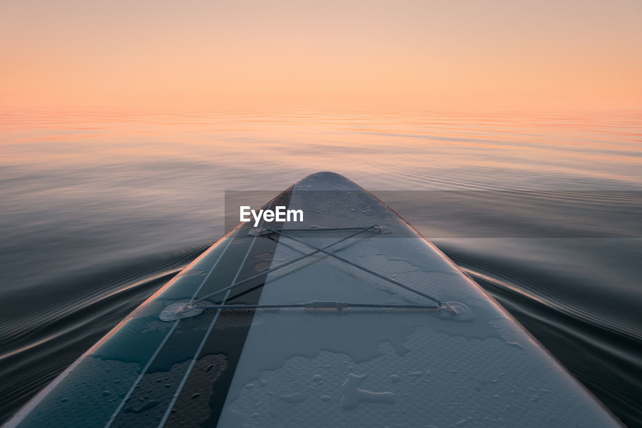 Paddleboard at sea. view from the board. sunset time.