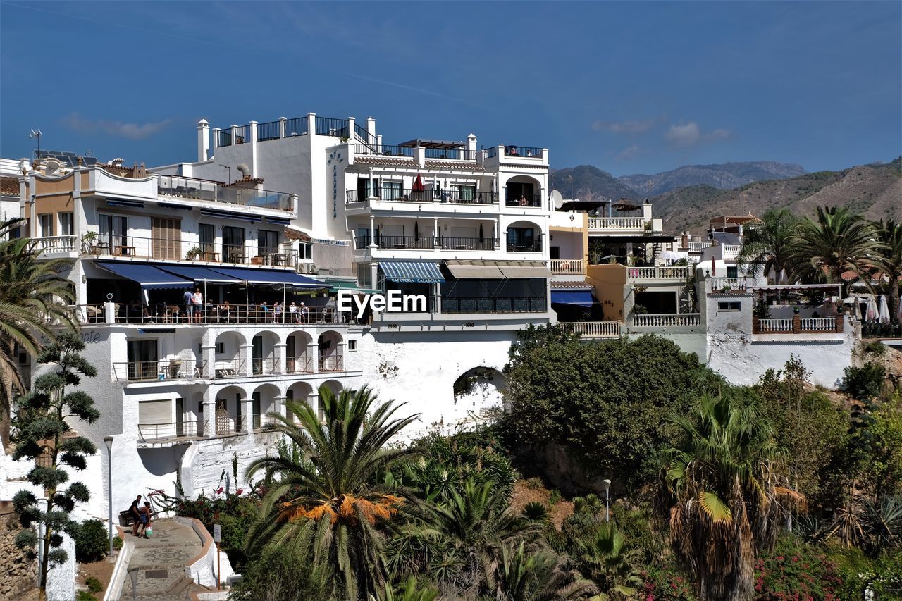 VIEW OF BUILDINGS WITH MOUNTAIN IN BACKGROUND