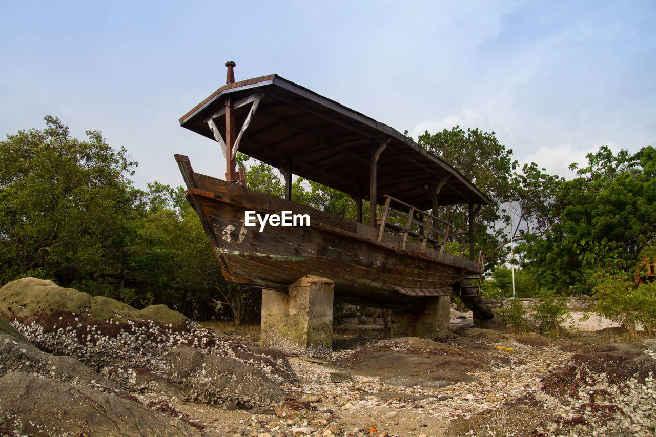 Exterior of abandoned boat against sky