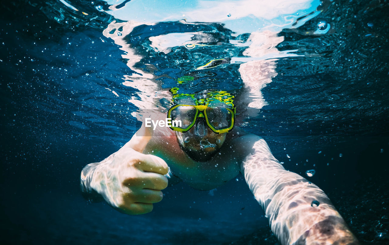 Portrait of man swimming in pool