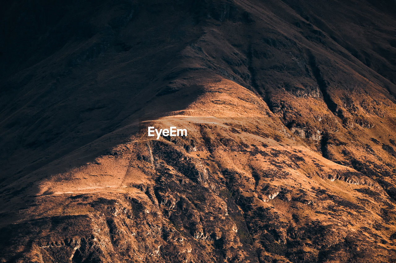 Shadow cast on the edge of a mountain ridge.