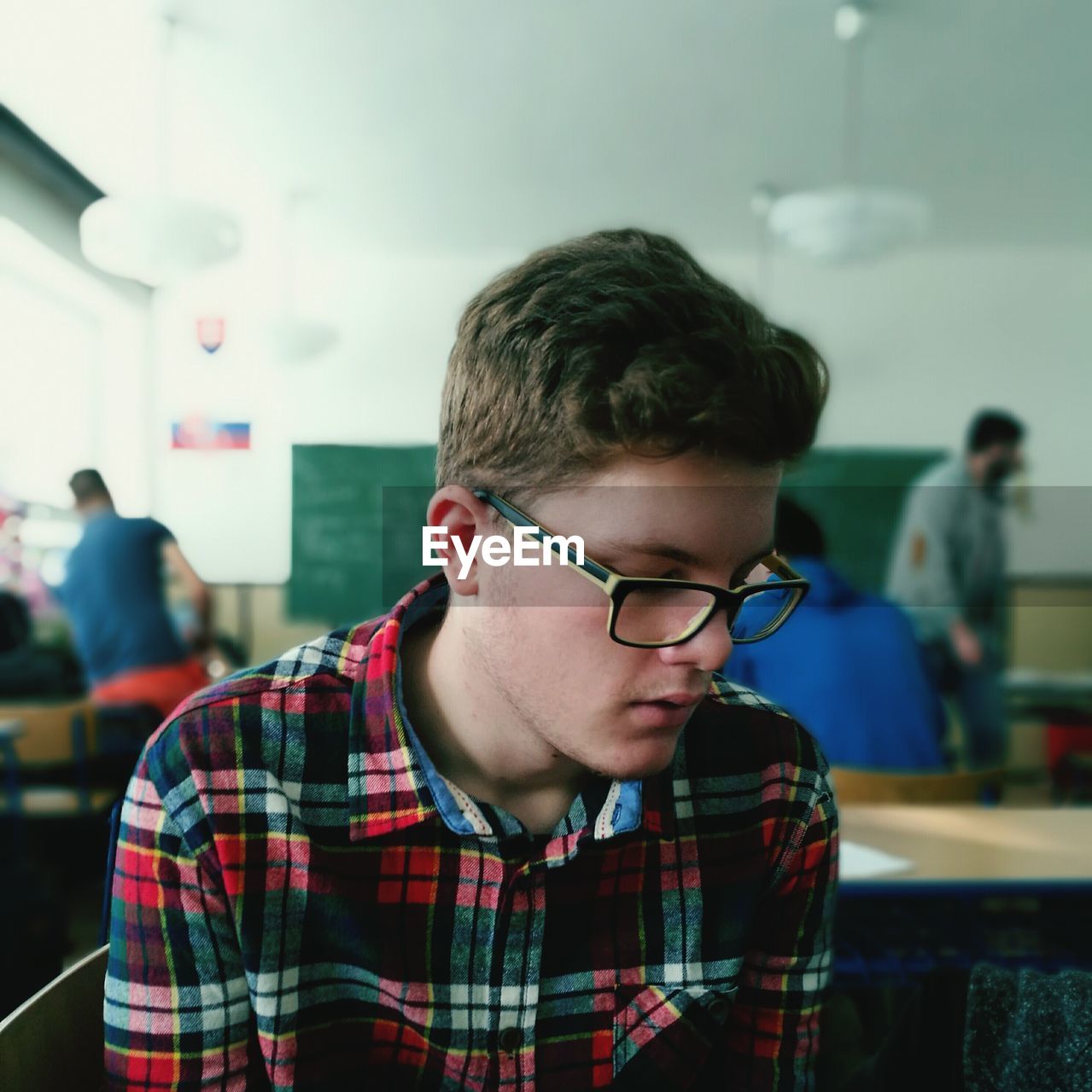 Young male student sitting in classroom