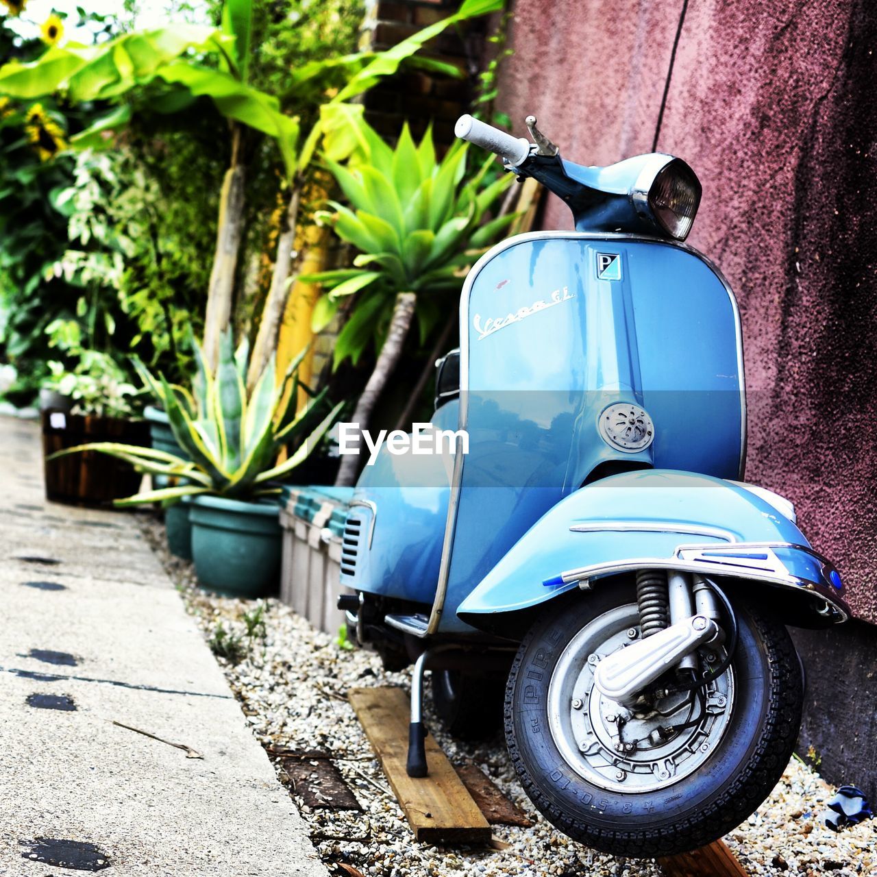 CLOSE-UP OF MOTOR SCOOTER ON WALL