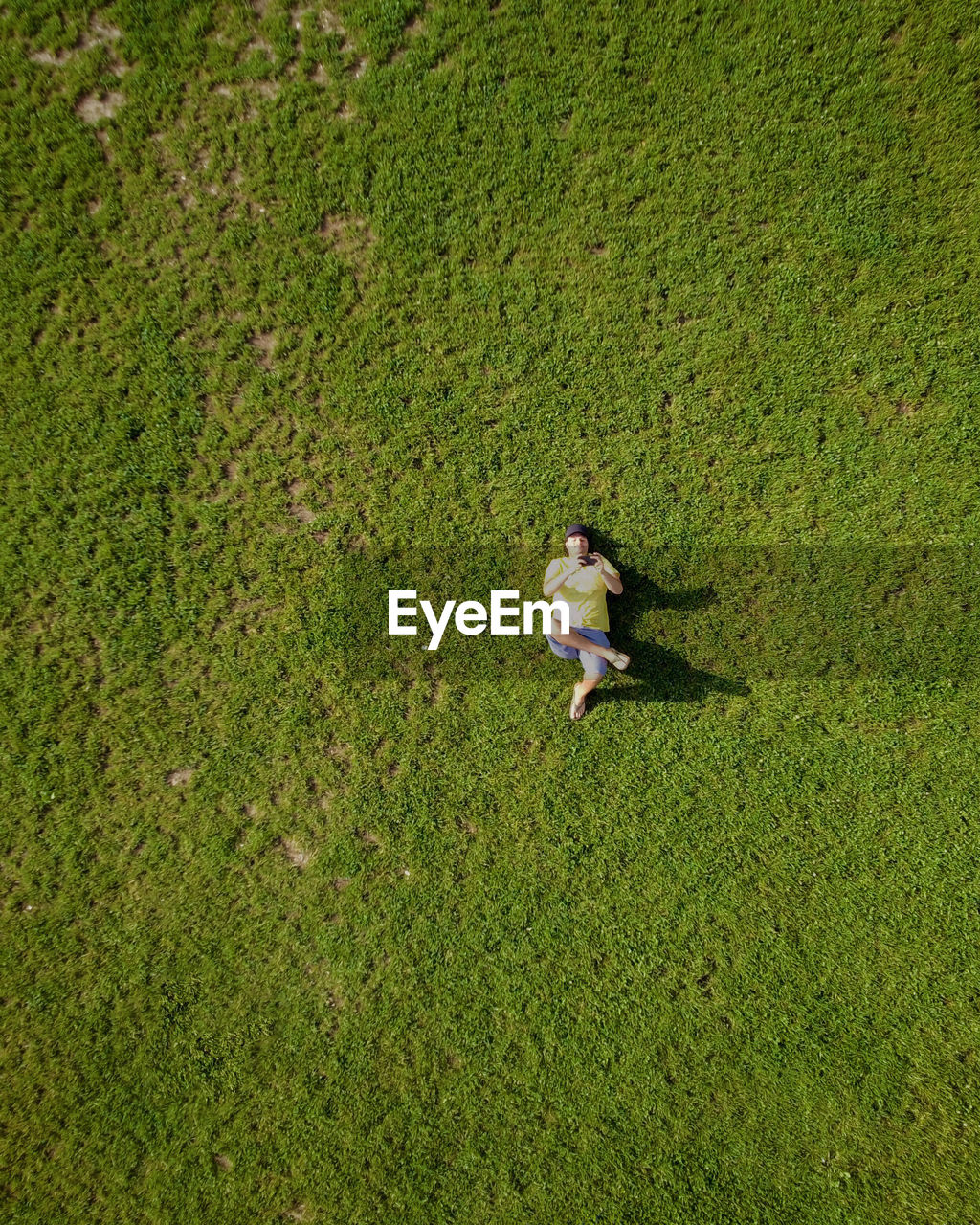 Aerial view of man lying on field