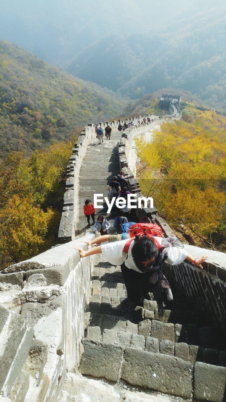 HIGH ANGLE VIEW OF PEOPLE ON RAILROAD TRACK