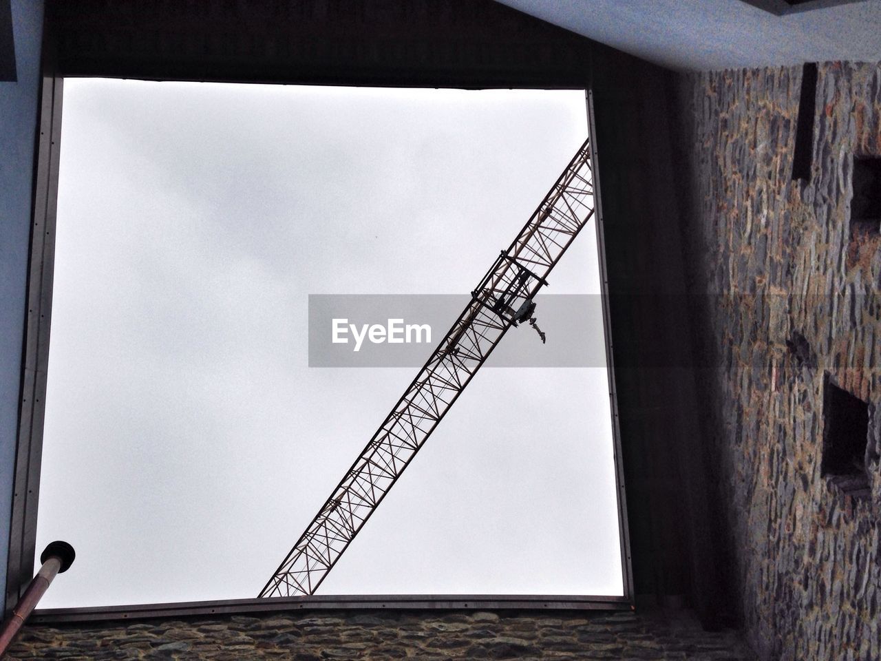 View of industrial crane from courtyard