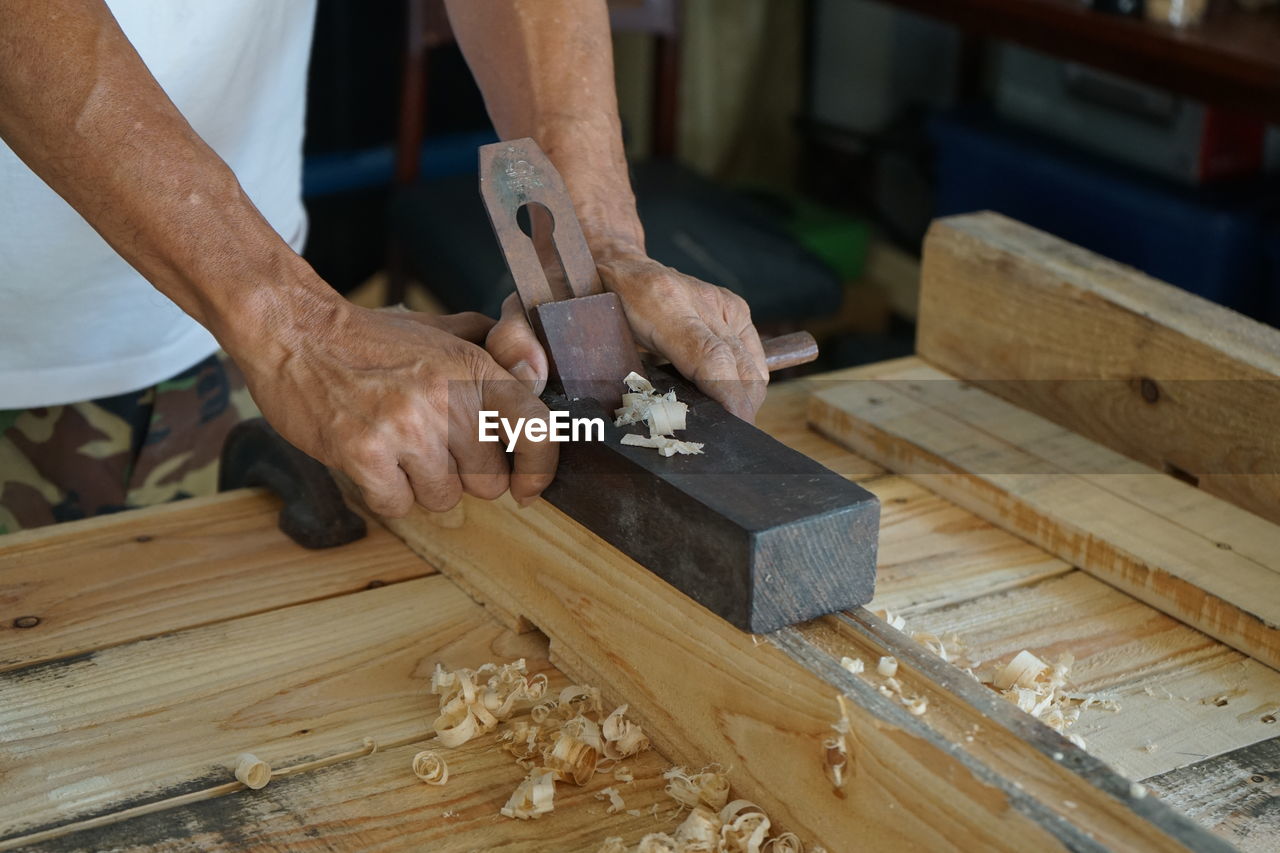 Woodwork and furniture making concept. carpenters are using spokeshave to decorate the woodwork.