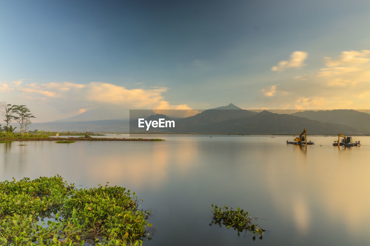 Scenic view of lake against sky during sunset