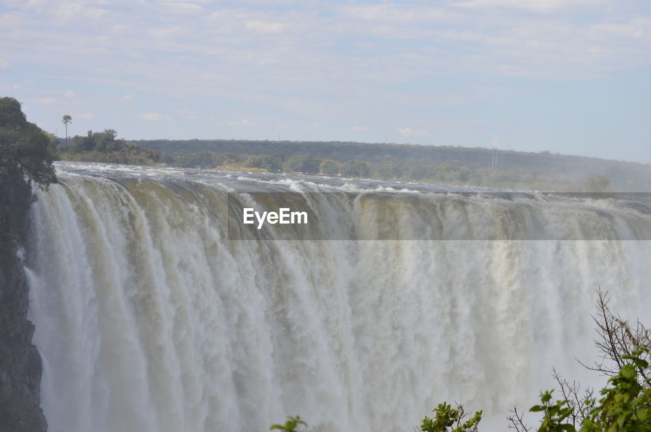 VIEW OF WATERFALL AGAINST SKY