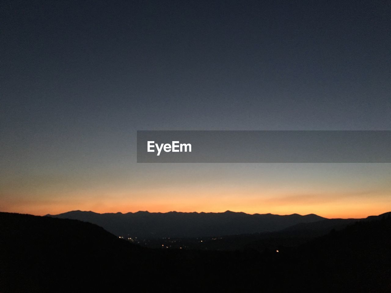 SILHOUETTE LANDSCAPE AGAINST CLEAR SKY AT SUNSET