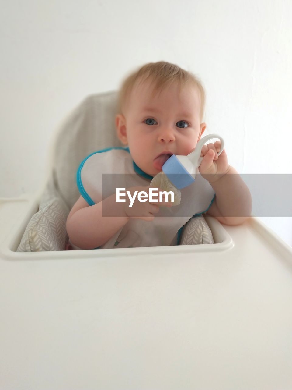 Portrait of cute baby girl sitting in stroller