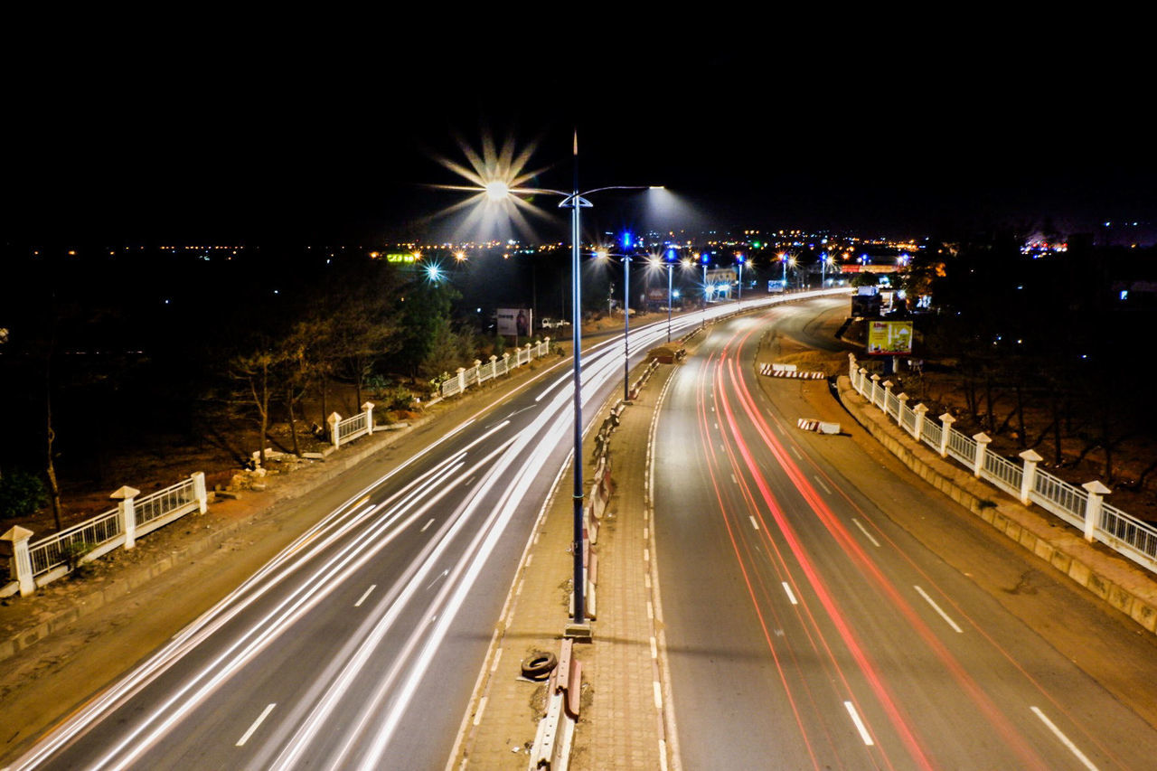 High angle view of light trails on highway at night