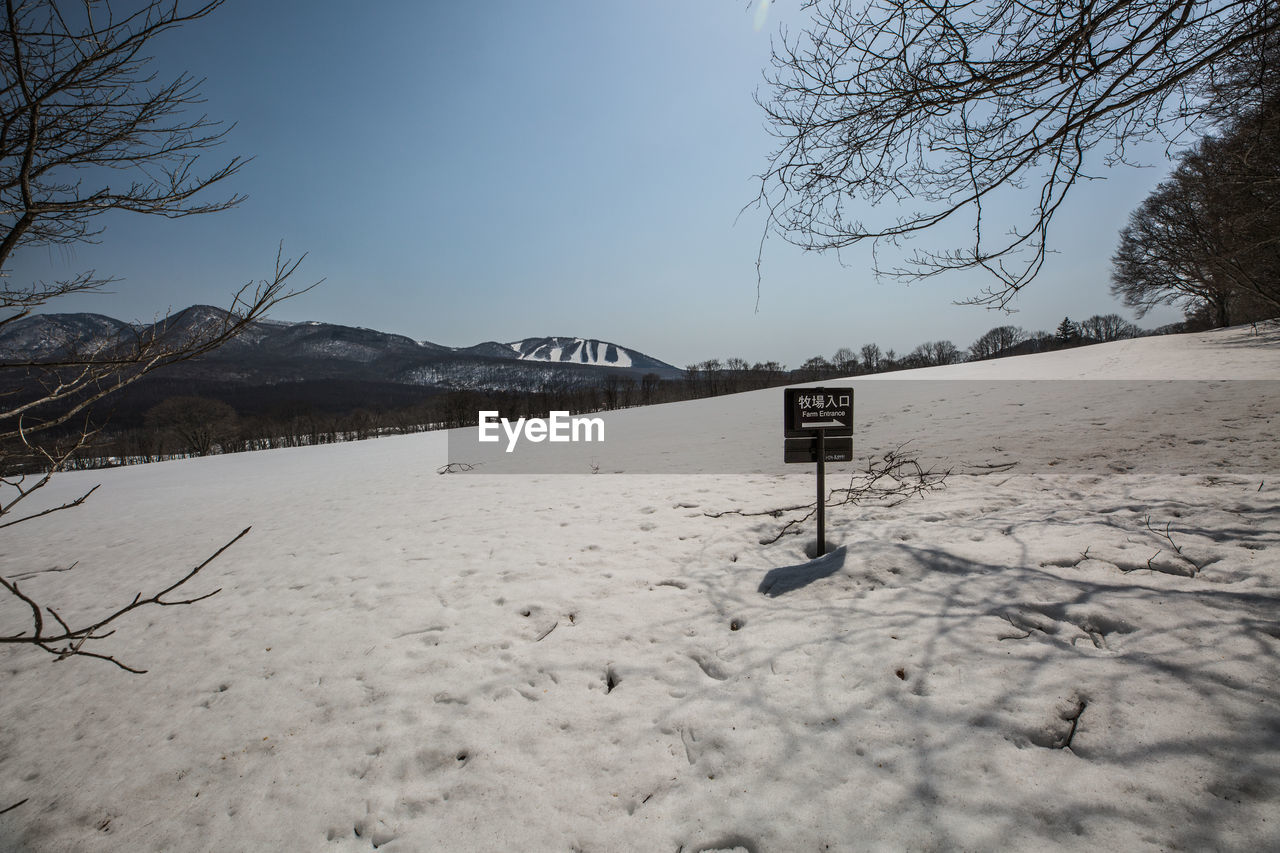 SNOW COVERED LAND AGAINST SKY