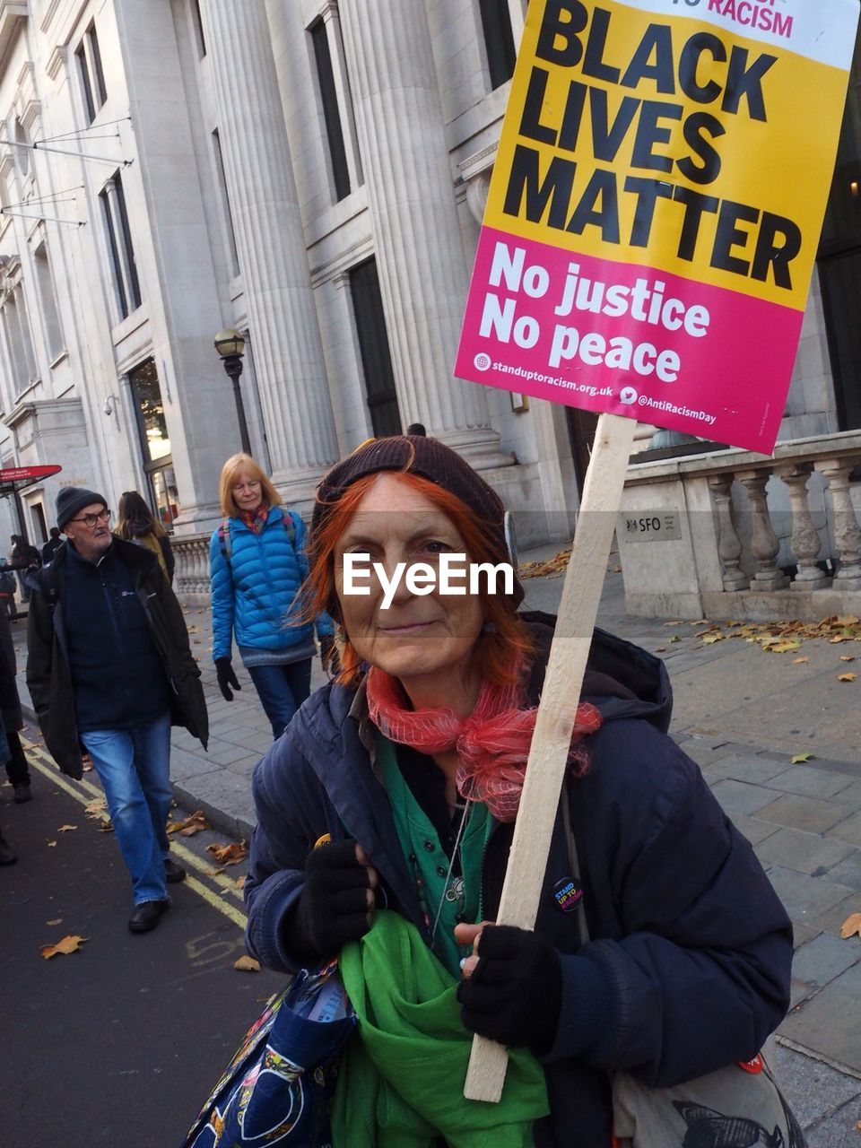 PORTRAIT OF A WOMAN WITH TEXT ON STREET