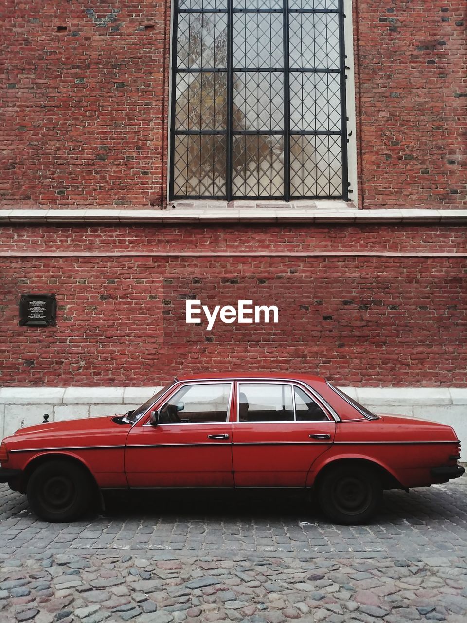 Vintage car on street against building