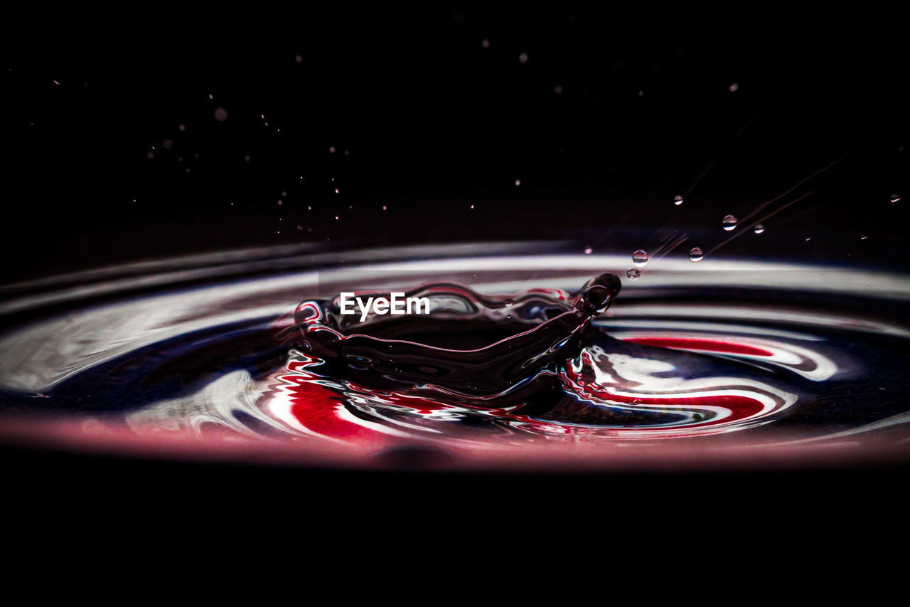 Close-up of water splashing against black background