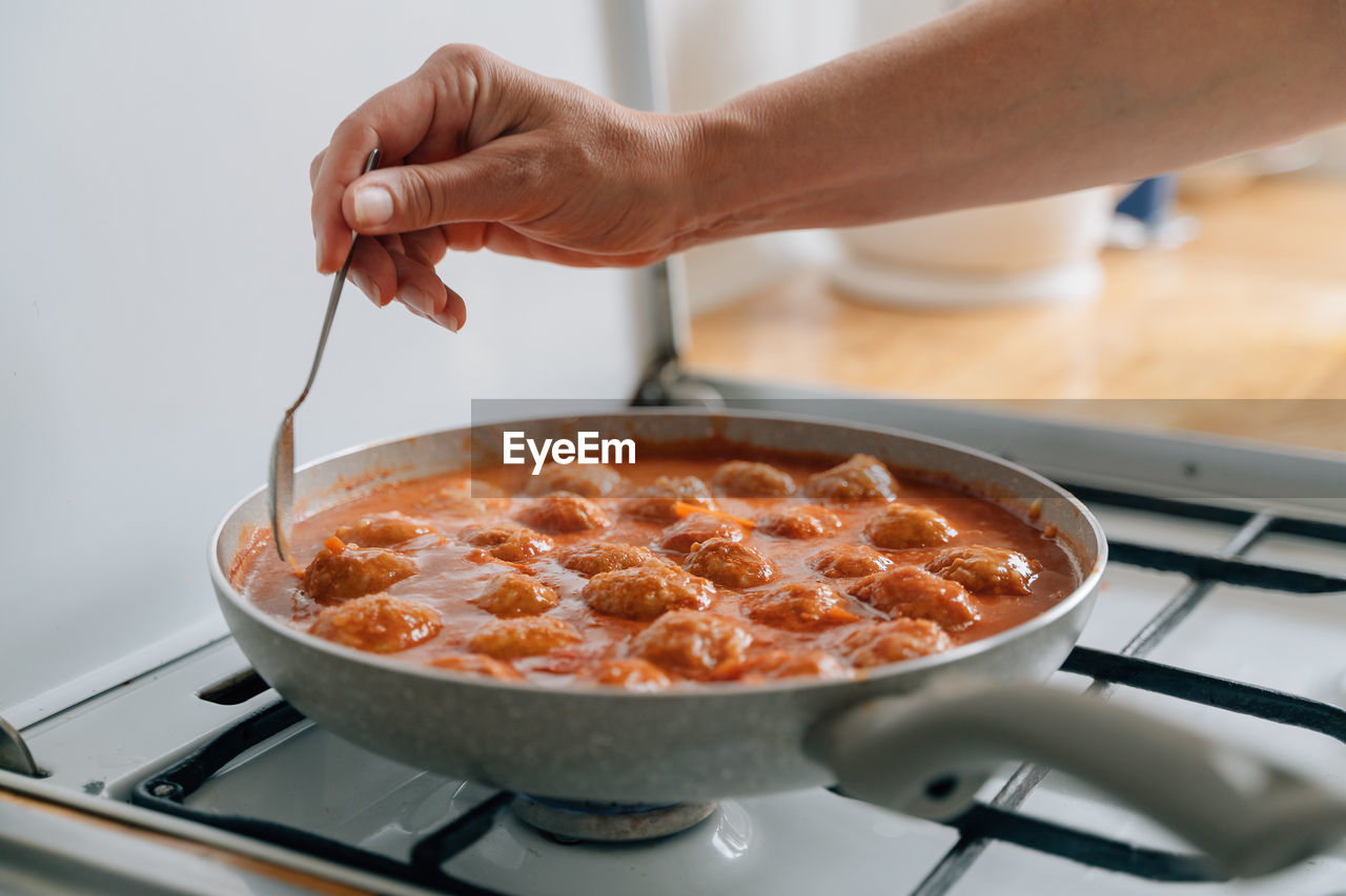 cropped hand of person preparing food