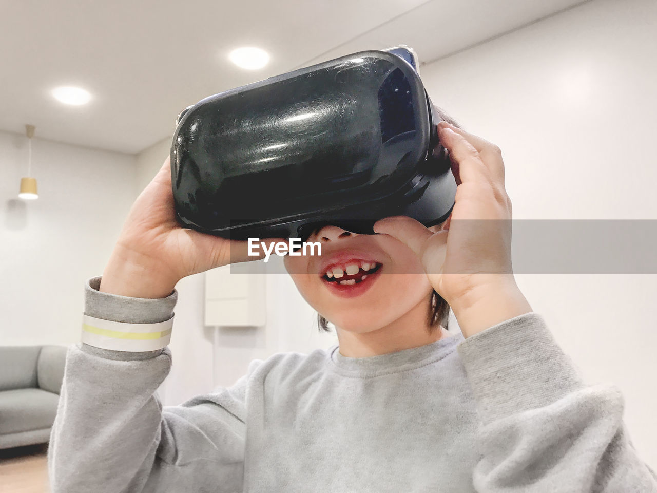 Smiling boy is watching something in vr-glasses. new technology for entertainment. 